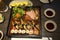 A Japanese Bento Box with rice, sushi, vegetables, and teriyaki kabayaki