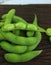 Japanese boiled green soybeans (edamame) healthy snacks on a wooden background