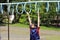 Japanese boy playing with a monkey bars