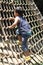 Japanese boy playing with rope ladder