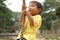 Japanese boy playing with Tarzan rope