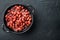 Japanese canned food ingredient, sweet red bean, on black background, top view flat lay with copy space for text