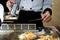 Japanese chef deliberately preparing and cooking traditional beef teppanyaki