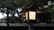 Japanese classic style wooden lamp pole with roof in shrine illuminated path way at night