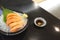 Japanese cuisine with copy space, Raw Salmon Sashimi with Wasabi on black bowl.