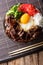 Japanese cuisine: gyudon beef with rice and onion. Vertical top