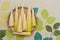 Japanese cuisine - Raw bamboo shoot peeled in a woven bamboo tray. Isolated on floral background.