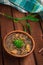 Japanese cuisine, soup with chashu pork, chives, sprouts, noodles and seaweed on the table under the sunlight. Wooden rustic backg