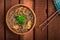 Japanese cuisine, soup with chashu pork, chives, sprouts, noodles and seaweed on the table under the sunlight. Wooden rustic backg