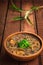 Japanese cuisine, soup with chashu pork, chives, sprouts, noodles and seaweed on the table under the sunlight. Wooden rustic backg