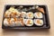 Japanese Cuisine: Tasty Uramaki , Futomaki and temaki served in the take-away box