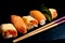Japanese cuisines nigiri sushi set on black plate served with wasabi, soy sauce. Sushi Roll with salmon, sushi maki roll and