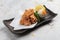 Japanese deep fried Chicken Karaage with cooking paper served with tempura sauce Tentsuyu mixing mince radish.