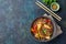 Japanese dish buckwheat soba noodles with chicken and vegetables carrot, bell pepper and green beans in grey bowl, top