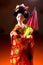 Japanese female kimono doll wearing red paper umbrella with flowers in hair and green glowing tritium trinket