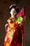 Japanese female kimono doll wearing red paper umbrella with flowers in hair and green glowing tritium trinket