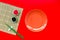 Japanese food cooking set with soy sauce, ginger, plate, bamboo sticks on red background top view copy space