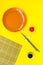 Japanese food cooking set with soy sauce, ginger, plate, bamboo sticks on yellow background top view copy space