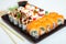 Japanese food rolls in plastic box. Sushi set in a plastic package close up isolated on a white background. Sushi for take away or