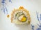 Japanese food style, Top view of Sushi salmon roll topped with salmon eggs on white plate
