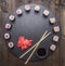 Japanese food, sushi with salmon and tuna, fresh ginger, soy sauce and chopsticks lined up on tray of chalk boards, frame, spac