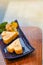 Japanese food, Tamago or grilled rolled omelet in a small blue plate and shape-like a Heart