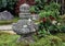 Japanese garden decorated stone cover by lichen moss and background the tree.