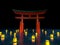 Japanese gate in water with lanterns at night