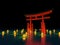 Japanese gate in water with lanterns at night