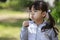 Japanese girl blowing dandelion seeds