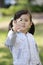 Japanese girl blowing dandelion seeds