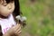 Japanese girl blowing dandelion seeds