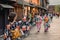 Japanese girl in kimono taking a photo of a traditional street with wooden houses on her phone in Kanazawa Japan