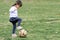 Japanese girl playing with soccer ball