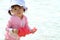 Japanese girl playing with water with watering pot