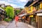 Japanese girl in Yukata with red umbrella in old town Kyoto