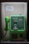 Japanese green public telephone on the street at night in Otaru, Japan.