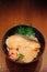 Japanese grilled snow fish donburi rice bowl on wood table in re