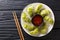 Japanese gyoza with matcha served with sauce and microgreen close-up. horizontal top view