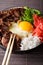 Japanese gyudon beef with rice, ginger and onions closeup. vertical