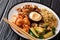 Japanese Hibachi recipe of rice, shrimp, steak and vegetables served with sauce closeup in a plate. horizontal