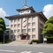 Japanese high school facade building with time clock in traditional classic style