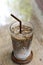 Japanese hojicha latte machiato coffee in the glass on wooden table