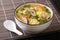 Japanese hot Rice Soup Zosui with chicken, egg and vegetables close-up in a bowl. Horizontal