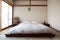 japanese-inspired bedroom, with minimalist design and crisp white linens