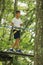 Japanese junior high school student playing at outdoor obstacle course on tree