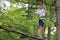 Japanese junior high school student playing at outdoor obstacle course on tree