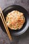 Japanese kani salad with crab sticks, glass vermicelli, carrot, cucumber and sesame seeds dressed with mayonnaise close-up in a
