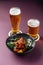 Japanese karaage chicken with beer on a purple