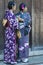 Japanese Ladies Posing in Geisha Kimono and taking Pictures At One of the Kyoto Streets, Japan